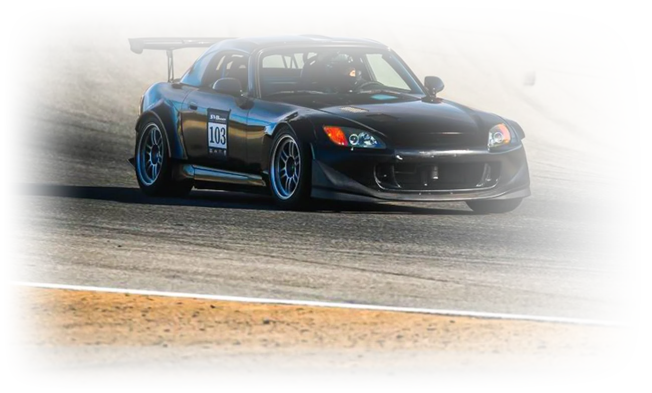 Track-prepped Honda S2000 mid-corner on a race circuit