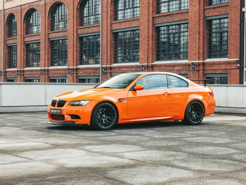 Orange BMW M3 coupe on black forged wheels