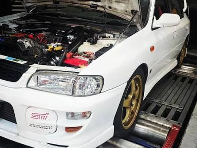 White Subaru Impreza STI on a dyno with the bonnet open