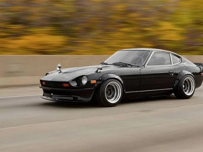 Black Datsun Z coupe with flared arches on the move