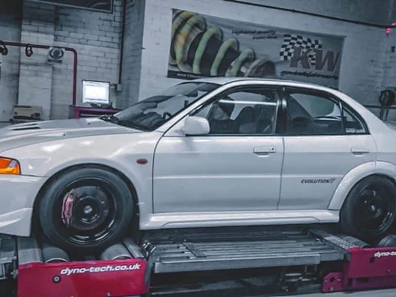 White Mitsubishi Lancer Evolution strapped to a dyno